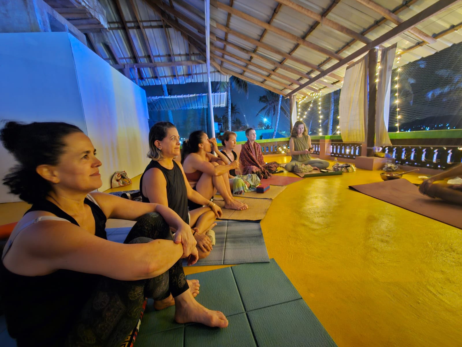 Méditation du soir en groupe, guirlandes lumineuses